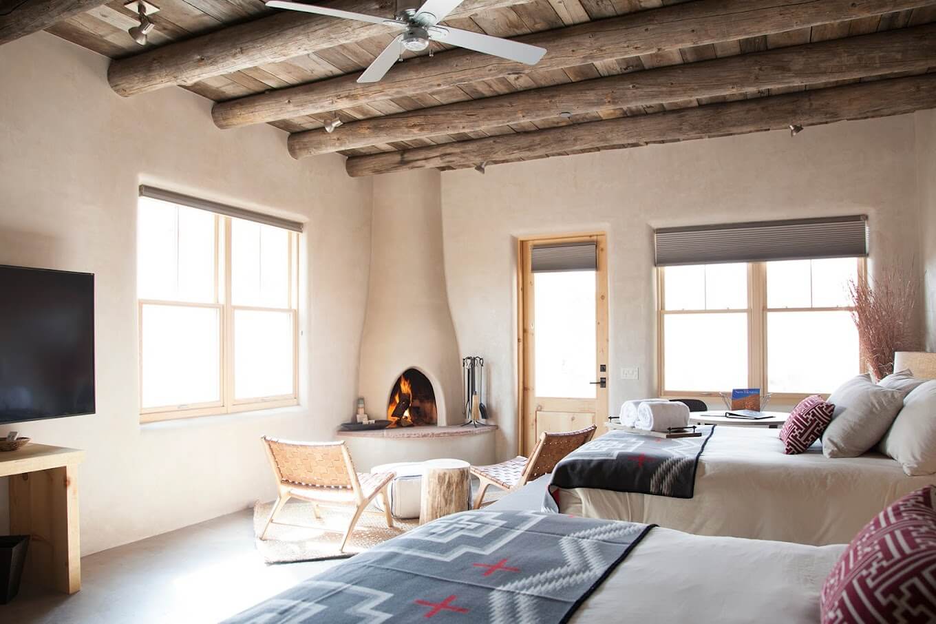 A cozy suite room with a kiva fireplace at Ojo Caliente resort. 