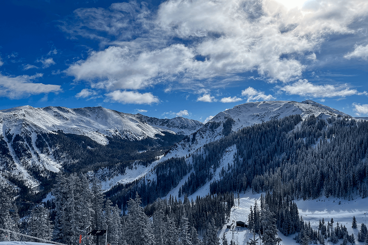 A view of distant ski runs at Taos Ski Valley on a bluebird day