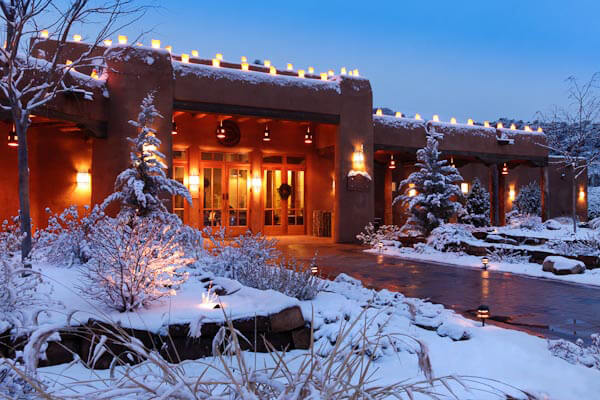 The main building at Ojo Caliente glows in the snowy evening light. 