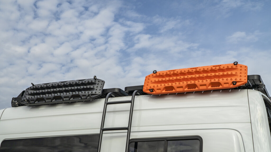 Maxtrax traction boards secured to the side of a sprinter van